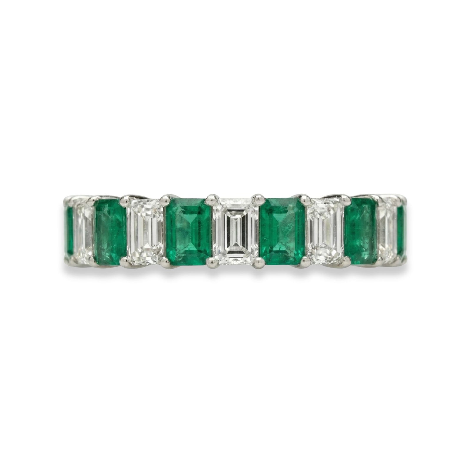 Platinum emerald cut eternity ring with alternating white diamonds and green emeralds