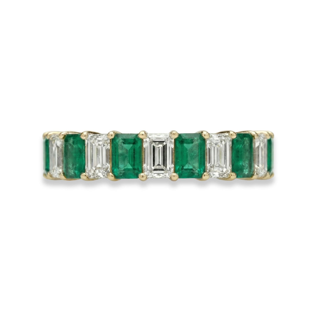 18K yellow gold emerald cut eternity ring with alternating white diamonds and green emeralds