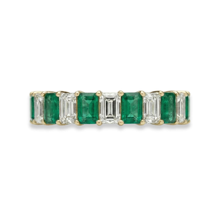 18K yellow gold emerald cut eternity ring with alternating white diamonds and green emeralds