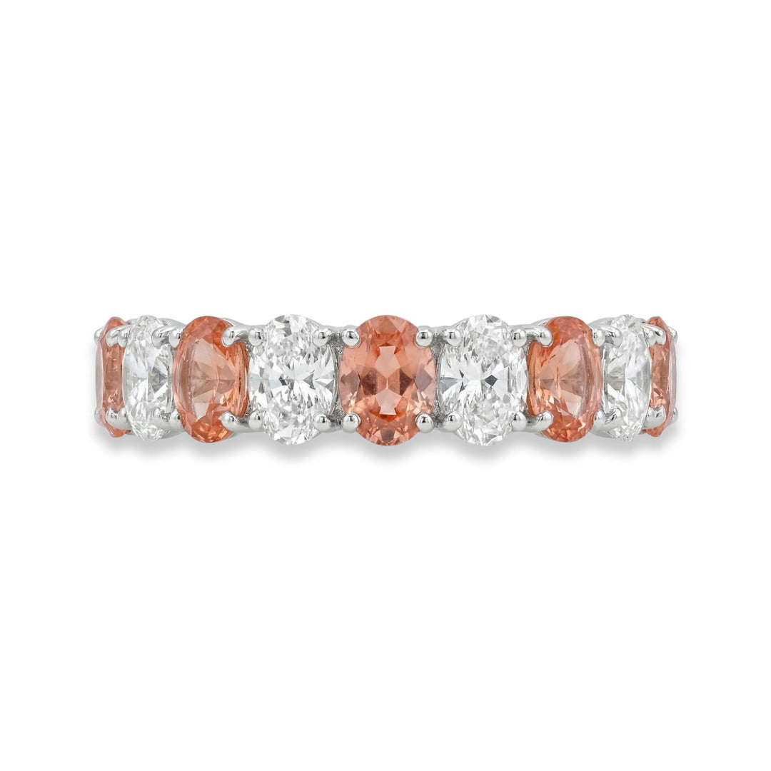 Platinum oval cut eternity ring with alternating diamond and Padparadscha sapphires