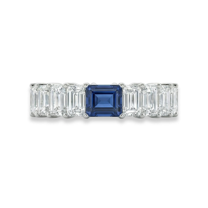 Platinum emerald cut eternity ring with blue sapphire center stone