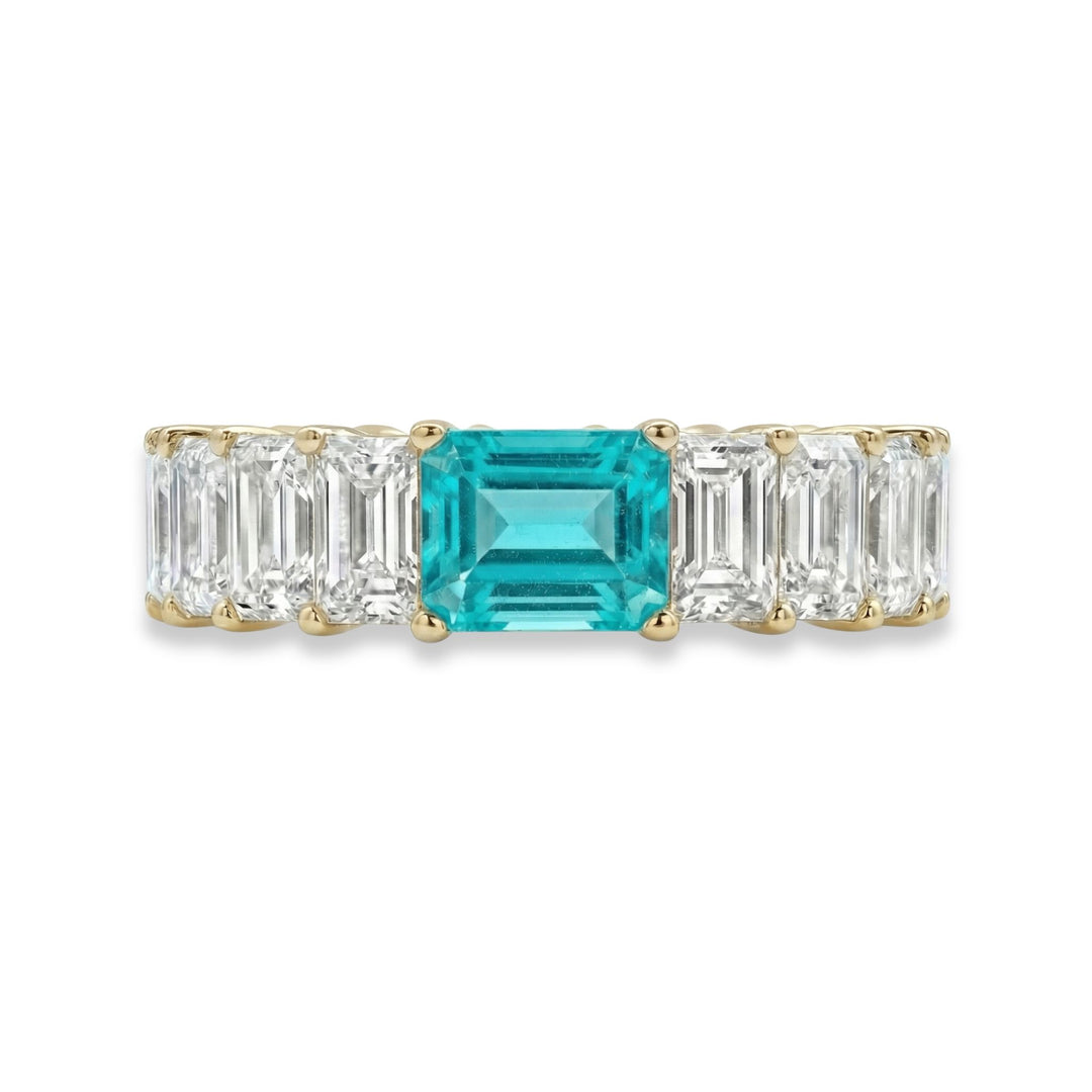 18K yellow gold Emerald Cut Eternity ring with paraiba stone in center