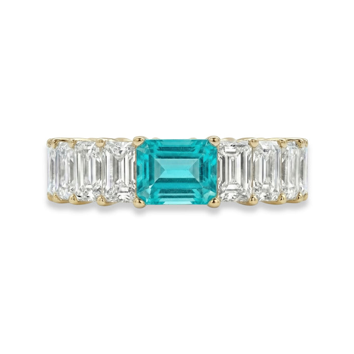 18K yellow gold Emerald Cut Eternity ring with paraiba stone in center