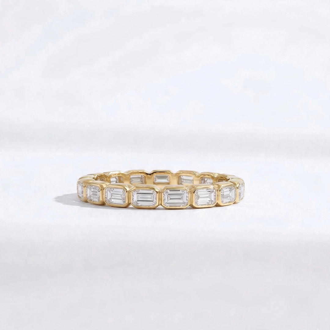 Yellow gold emerald-cut diamond eternity ring handcrafted by M Grace Jewelry