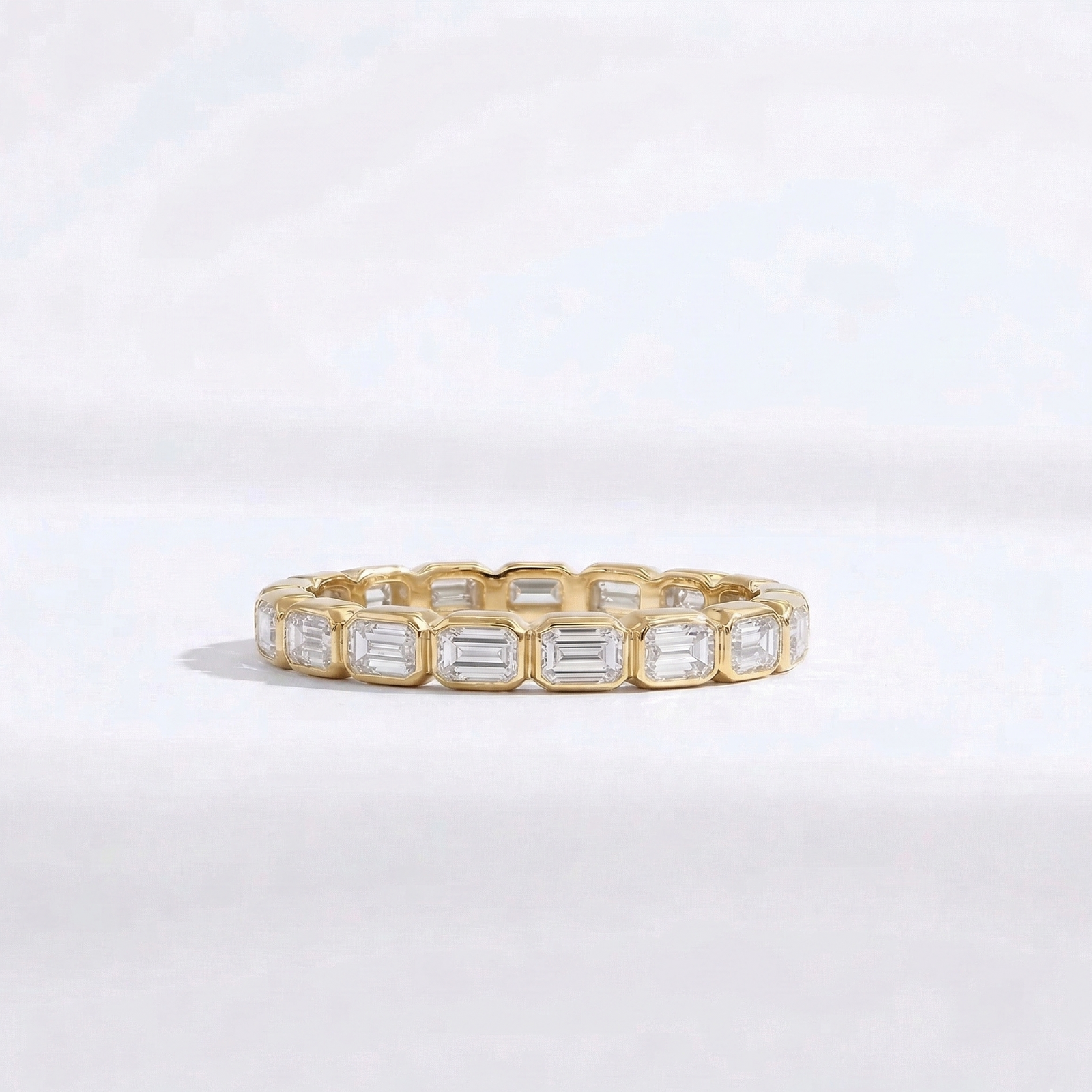Yellow gold emerald-cut diamond eternity ring handcrafted by M Grace Jewelry