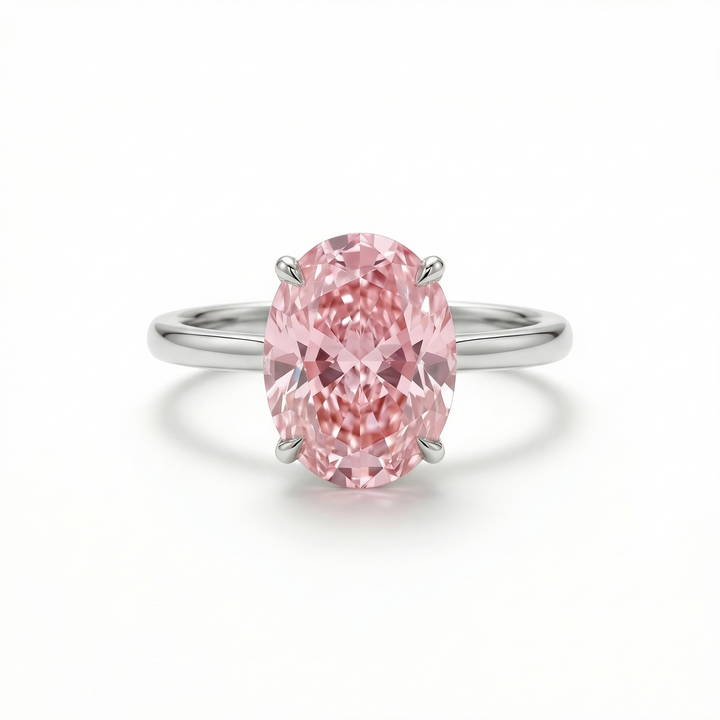 Fancy Intense Pink oval diamond solitaire ring in platinum — M Grace Jewelry