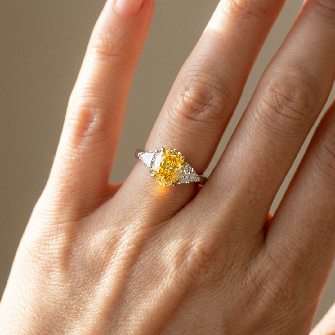 Fancy Intense Yellow oval diamond ring with white trillion sides — M Grace Jewelry
