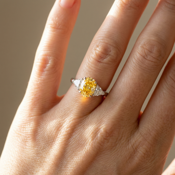 Fancy Intense Yellow oval diamond ring with white trillion sides — M Grace Jewelry
