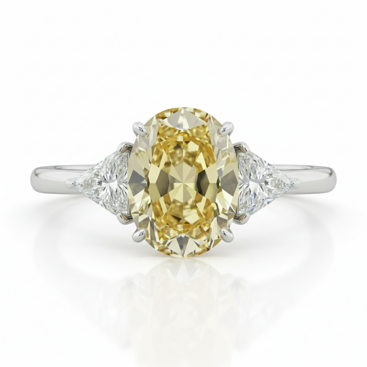 Fancy Intense Yellow oval diamond ring with white trillion sides — M Grace Jewelry